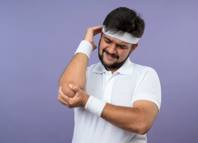 Golfer's Elbow - injured-young-sporty-man-wearing-headband-wristband-grabbed-aching-elbow