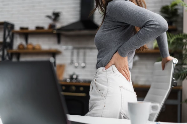 Living with Sciatica - side-view-woman-having-backache-while-working-from-home